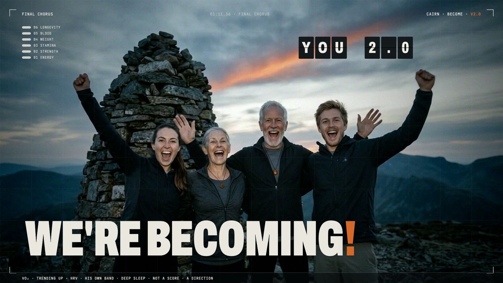 Mara and Dan at sixty-five with their grown children, arms up at the cairn